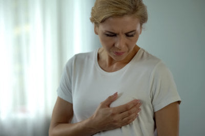 a woman having a breast pain